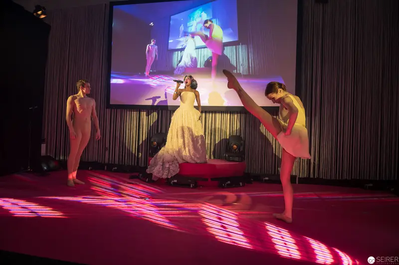 Performance Art Stage: Dancers and Singer in Vibrant Multimedia Staging