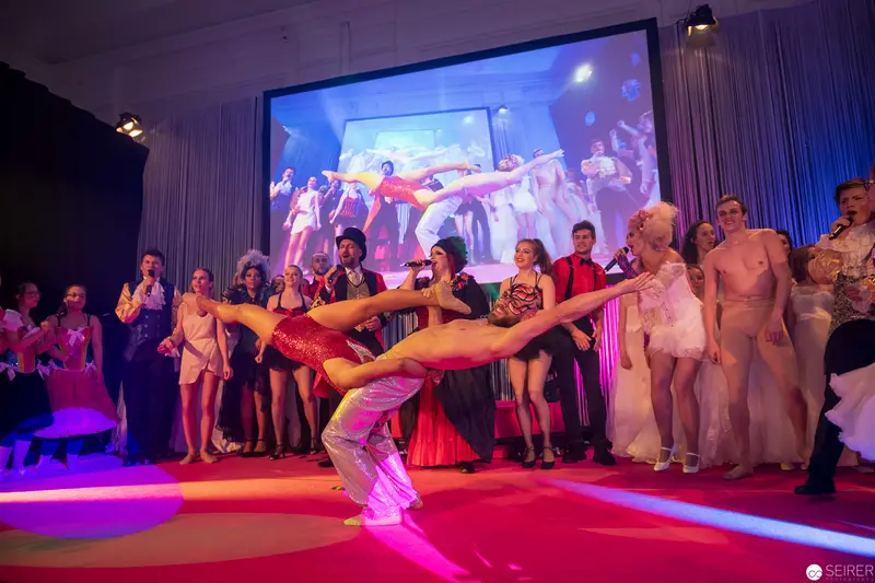 Dynamic Performance Finale with Dancers in Vibrant Theatrical Staging