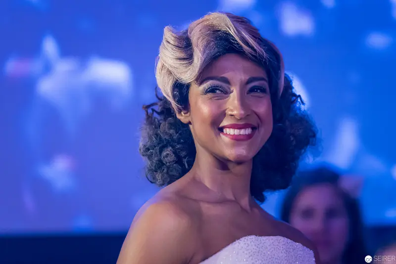 Vintage-Styled Portrait of Smiling Performer in Blue Stage Lighting