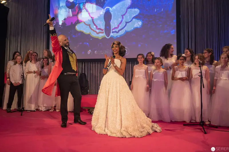 Celebratory Performance with Soloist in White Gown and Choir Ensemble