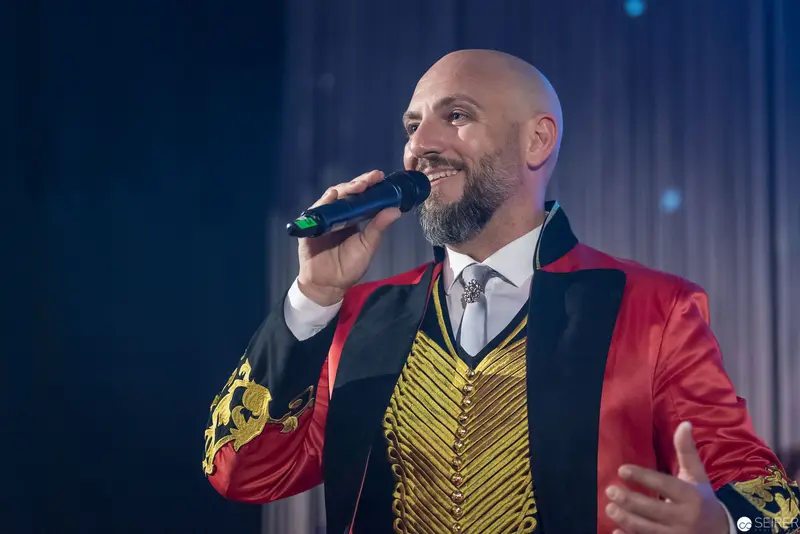 Stage Performance in Theatrical Red and Gold Ringmaster-Style Costume