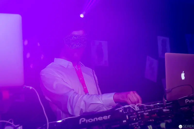Electronic Music Performance with Pioneer DJ Equipment under Purple Stage Lighting