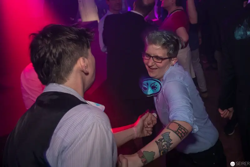 Dancing Intimately at Nightclub Event with Vibrant Pink and Purple Lighting
