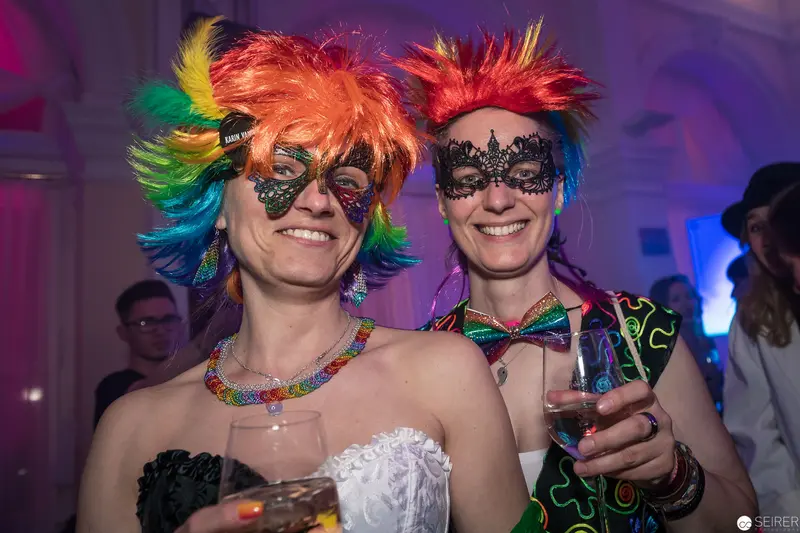 Rainbow Wigs and Masquerade: Festive Costumed Revelers at Carnival Party