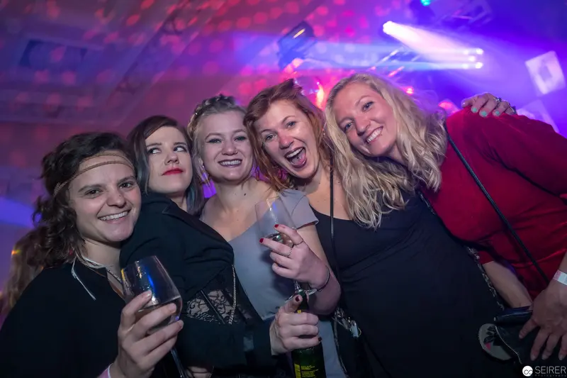 Five Women Enjoying Night Out in Vibrant Club Lighting Atmosphere