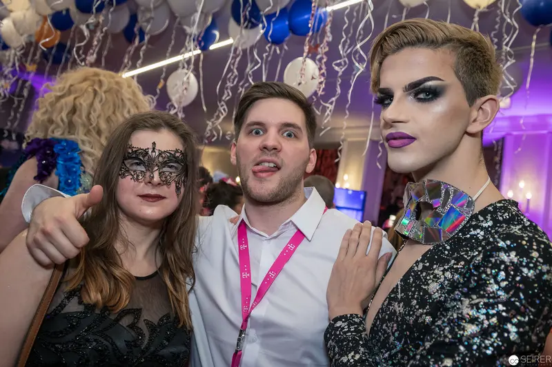 Masked Revelers at Glittering Masquerade Party with Elaborate Costumes