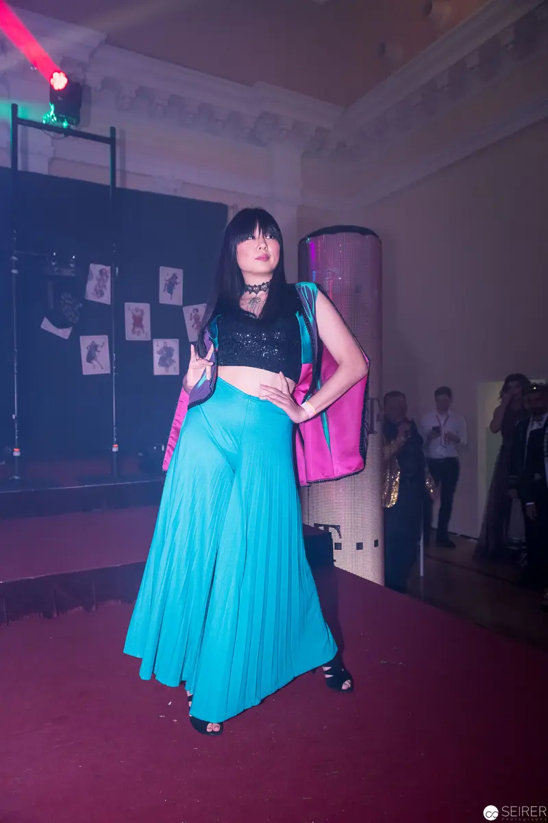 Performance in Vibrant Blue Skirt and Black Top under Stage Lighting