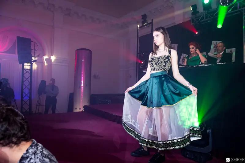 Fashion Model Performing on Runway with Dramatic Stage Lighting and DJ Setup