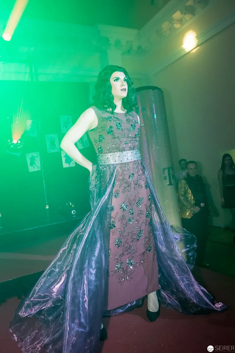 Emerald-Lit Fashion Runway Model in Ornate Embellished Evening Gown