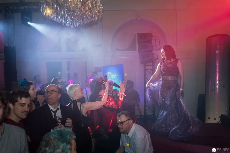 Elegant Evening Gown Performance at Glamorous Staged Event with Dramatic Lighting