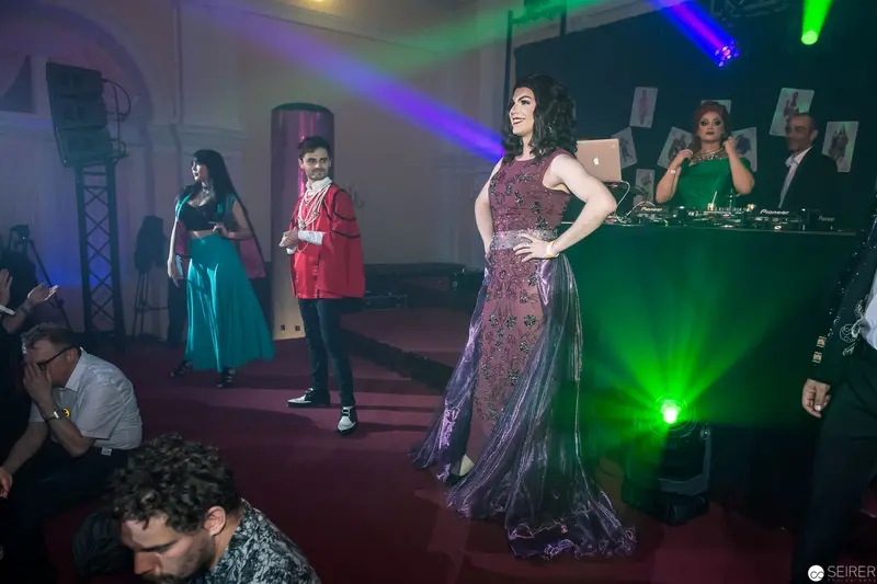 Fashion Show Runway with Dramatic Lighting and Diverse Evening Gown Styles