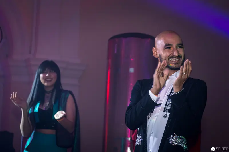 Performers Applauding during Energetic Stage Performance with Dramatic Lighting