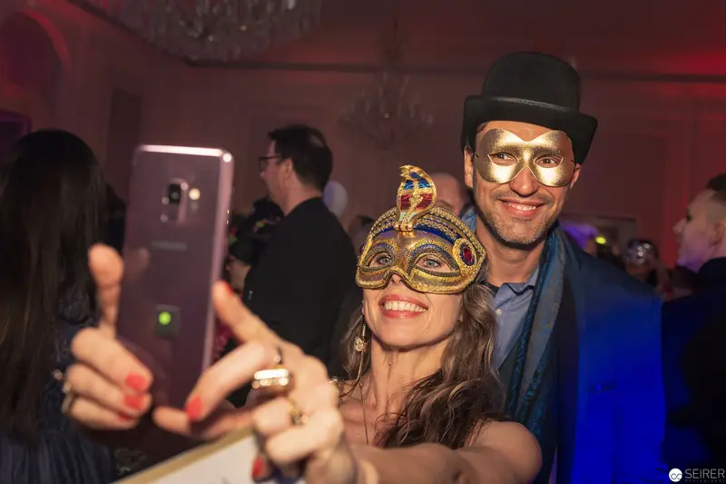 Masquerade Selfie: Costumed Couple at Festive Evening Celebration