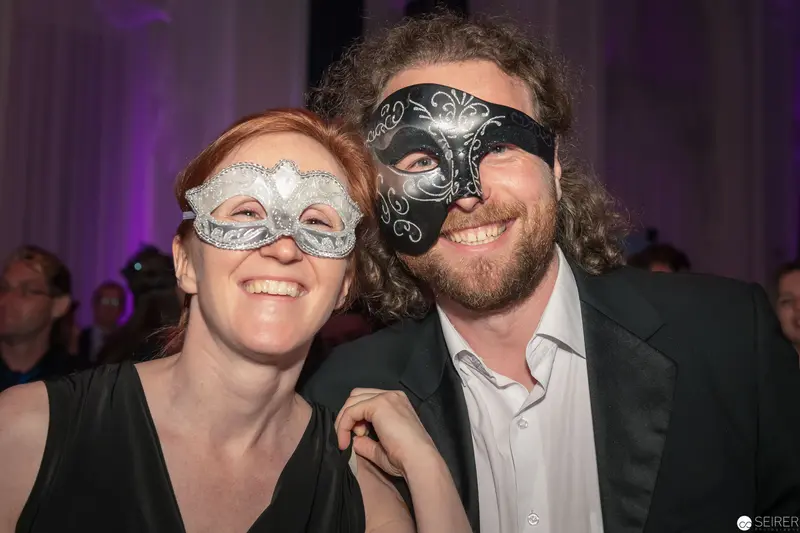 Masked Couple at Evening Gala, Smiling in Silver and Black Ornate Masks