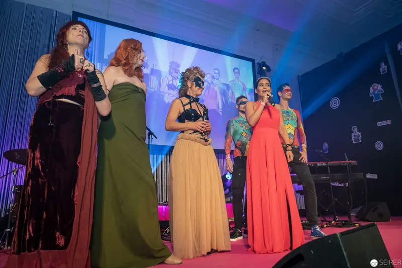 Female Vocal Ensemble Performance on Illuminated Stage with Blue Lighting