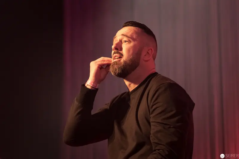 Performer in Dramatic Pose with Intense Emotional Expression under Warm Stage Lighting