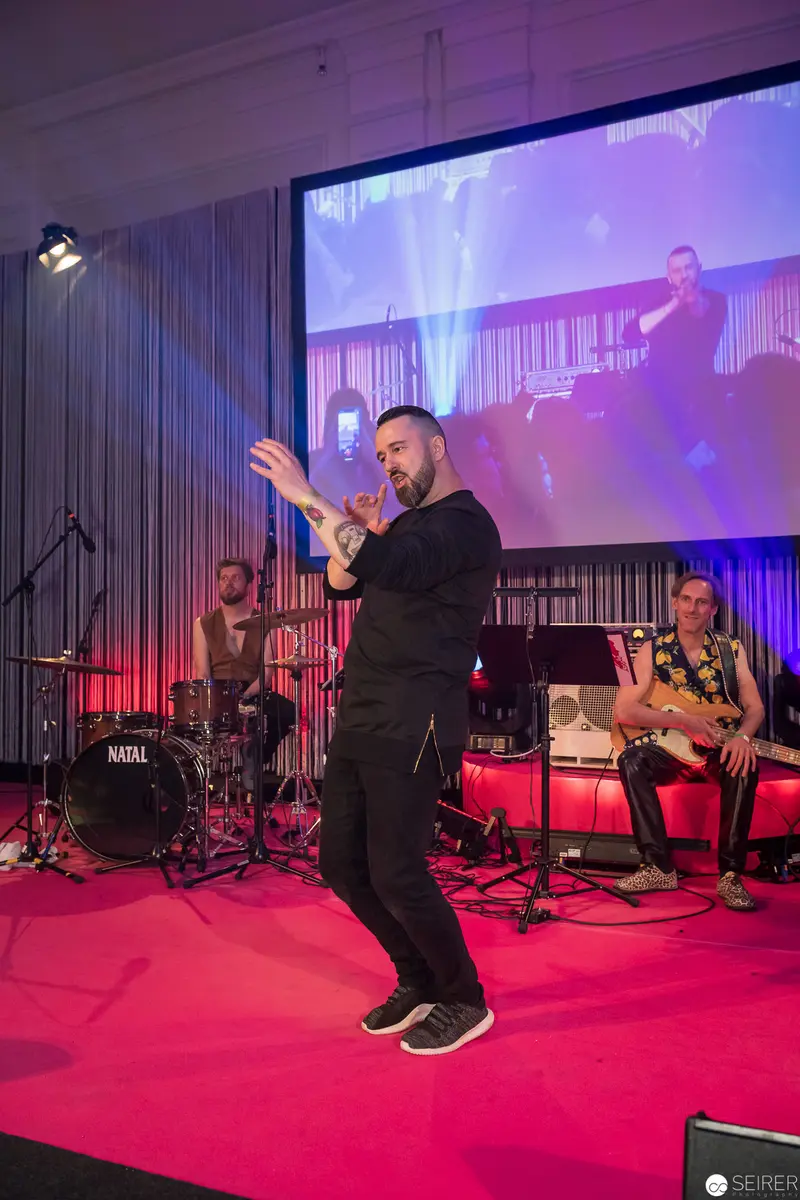 Performance Stage with Singer, Drummer, and Projected Background