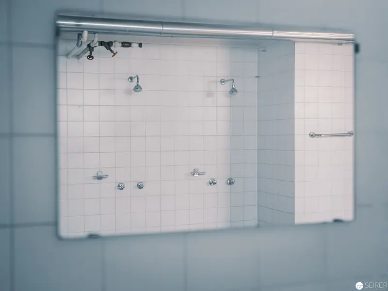 Minimalist Shower Installation with Architectural Lighting and Tiled Wall