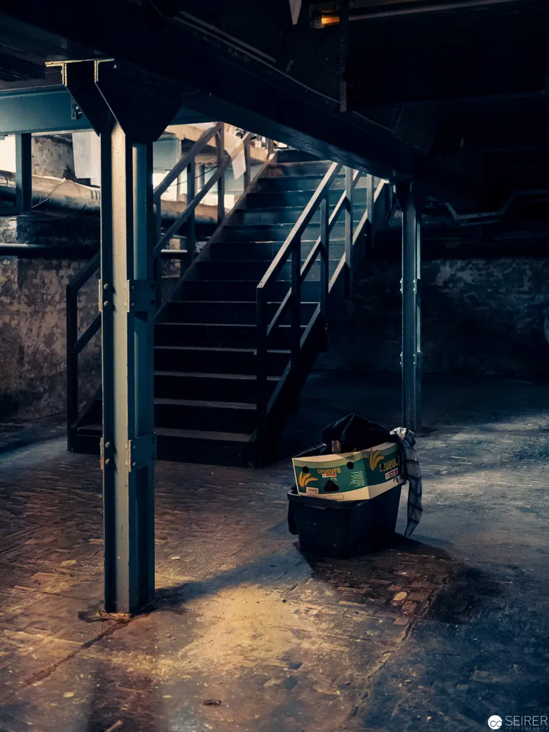 Abandoned Stairwell with Illuminated Bag in Moody Industrial Setting