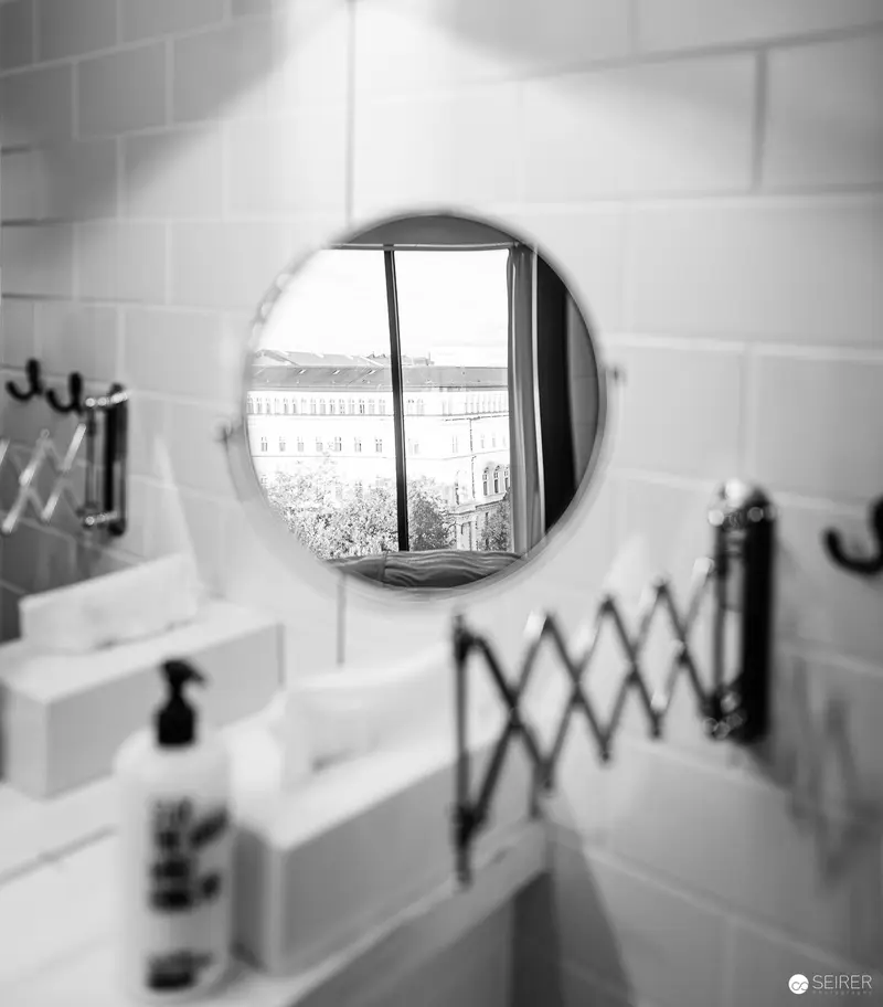 Reflective Geometry: Bathroom Mirror with Expandable Arm and Tiled Wall