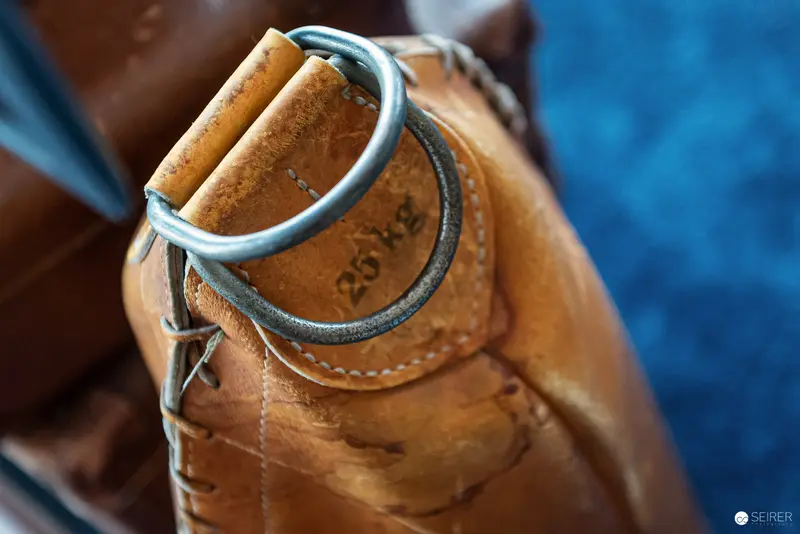 Close-Up of Vintage Leather Water Bottle with Metal Ring and Stitching