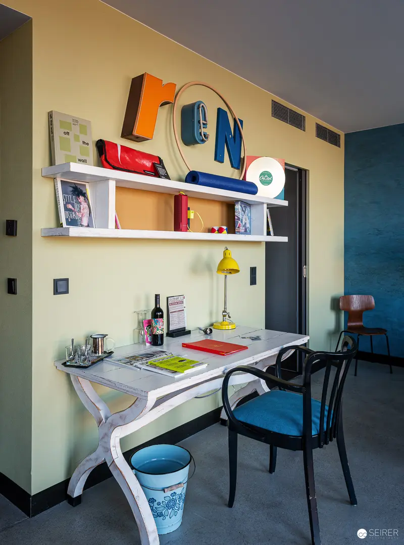 Colorful Contemporary Workspace with Floating Shelves and Eclectic Design Elements