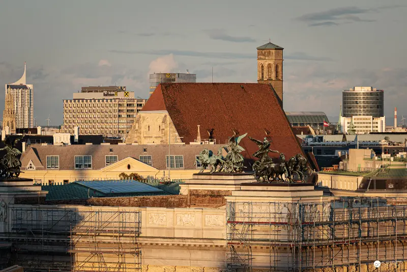 Urban Landscape of Central European City with Historic Architecture and Bronze Sculpture