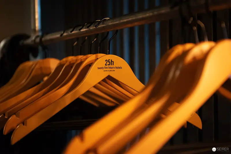Wooden Hangers with Numbered Design Marker in Warm Ambient Lighting