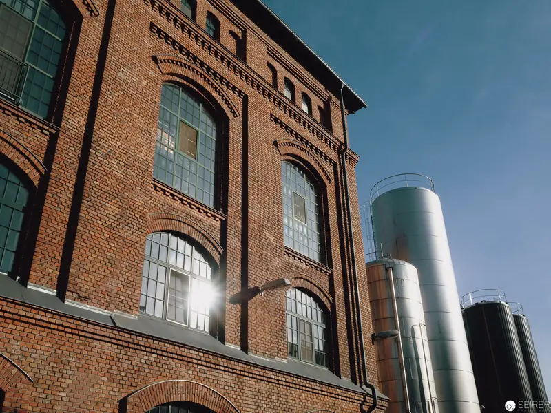 Industrial Architecture: Brick Factory Building with Modern Steel Storage Tanks