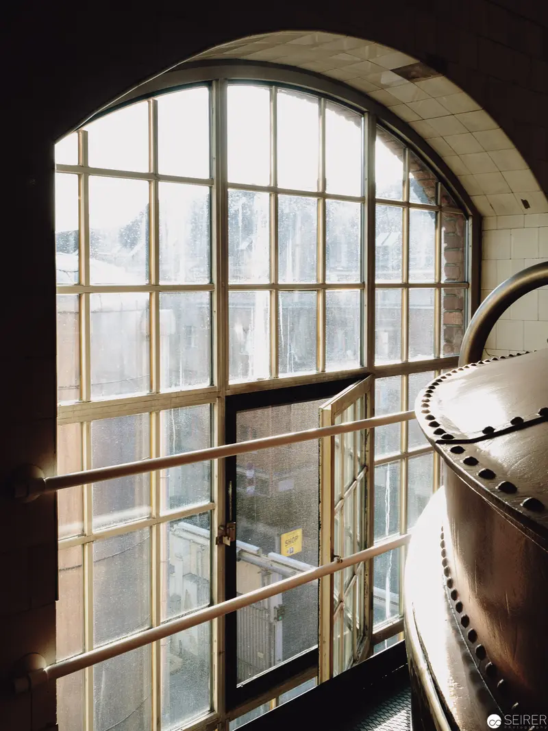 Arched Industrial Window with Curved Architectural Metal Structure