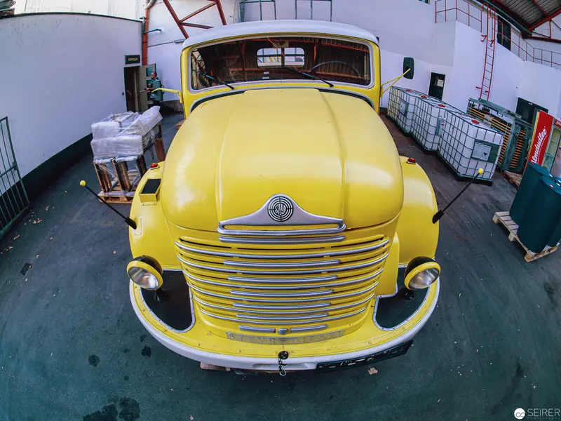 Vintage Yellow Cabover Truck in Industrial Warehouse Interior
