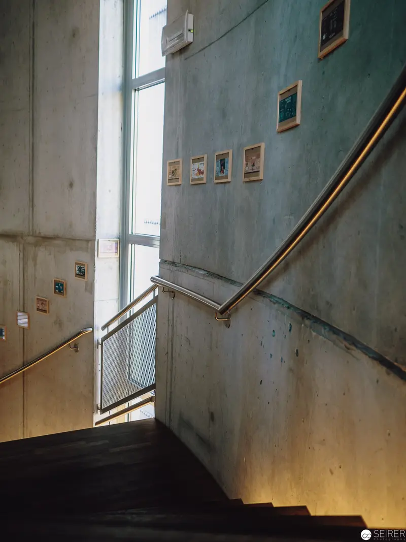 Architectural Interior with Curved Staircase and Framed Artwork