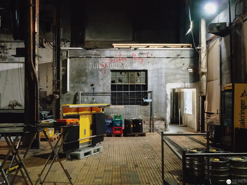 Nocturnal Industrial Workspace with Colored Storage Containers and Ambient Lighting