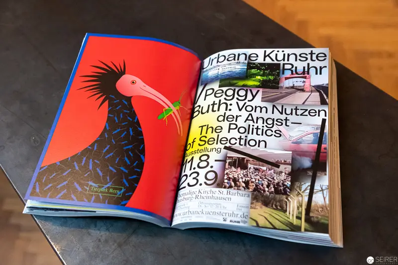 Open Art Book Showcasing Peggy Guth's Urban Arts Ruhr Exhibition Design