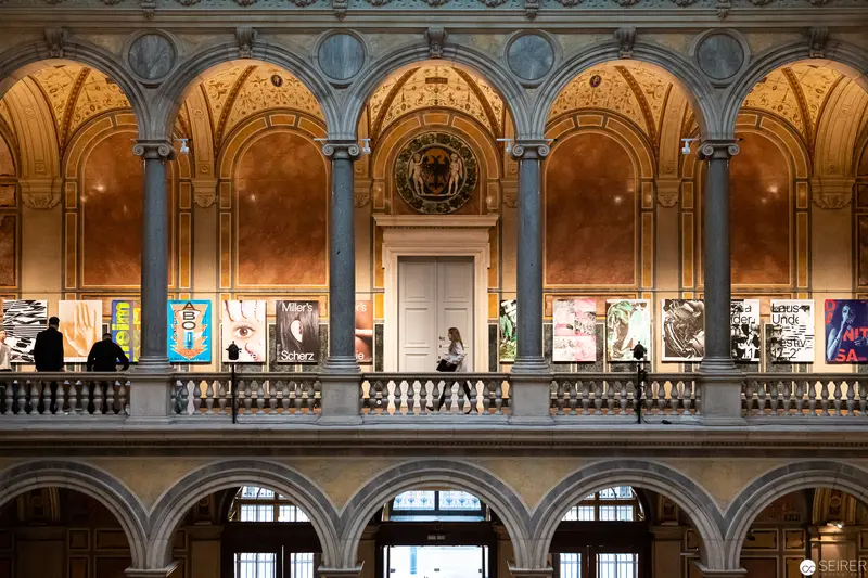 MAK Vienna Art Exhibition: Architectural Interior with Poster Display and Visitors
