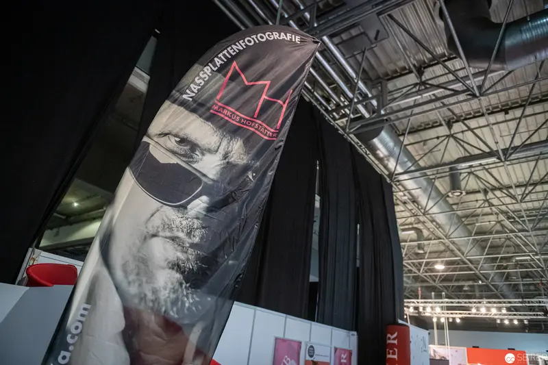 Large-Scale Photography Exhibition Banner with Stylized Portrait Featuring Crown Motif