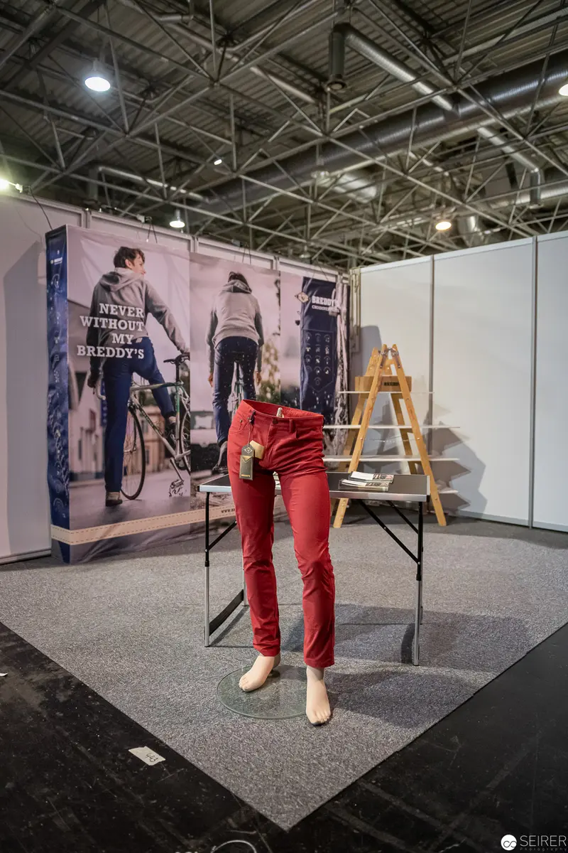Red Trousers on Display: Exhibition Stand with Photographic Backdrop