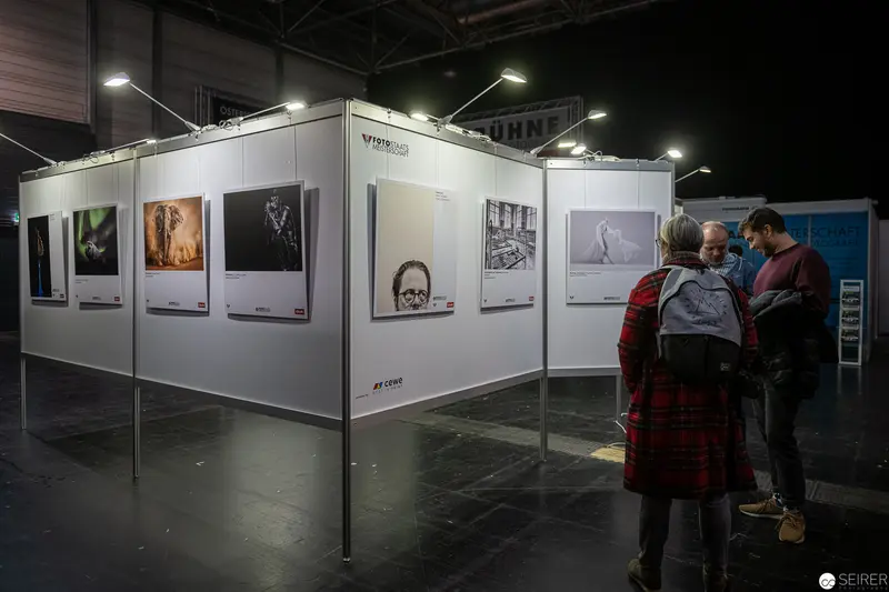 Photographic Exhibition with Visitors Studying Gallery Wall Displays