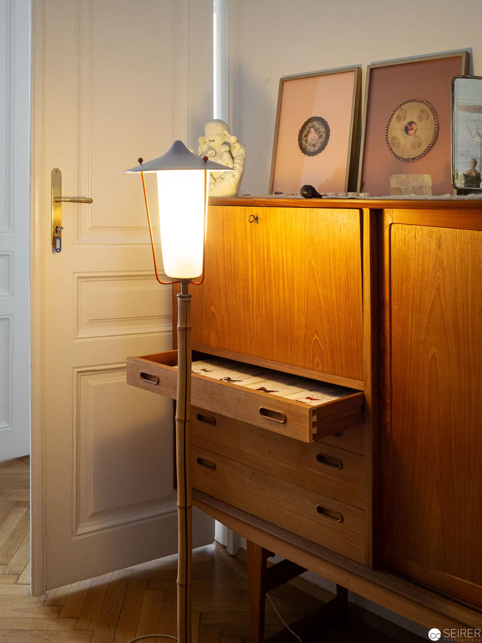 Mid-Century Modern Interior with Illuminated Wooden Sideboard and Floor Lamp
