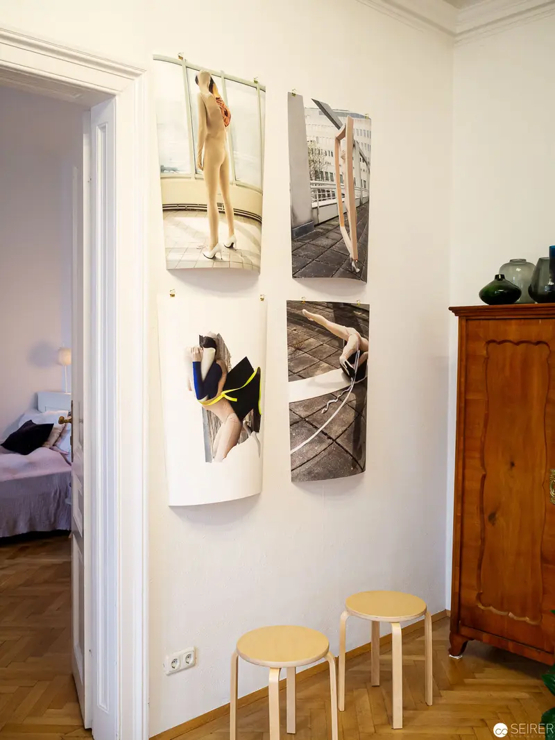 Gallery Interior with Curved Photographic Prints and Minimal Wooden Furnishings