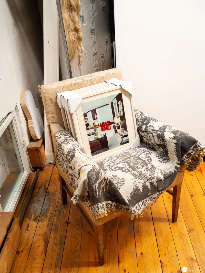 Vintage Television on Ornate Chair with Tapestry Throw in Wooden Interior