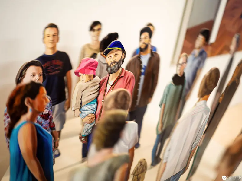Diverse Urban Crowd in Layered Photographic Installation with Lifelike Figures
