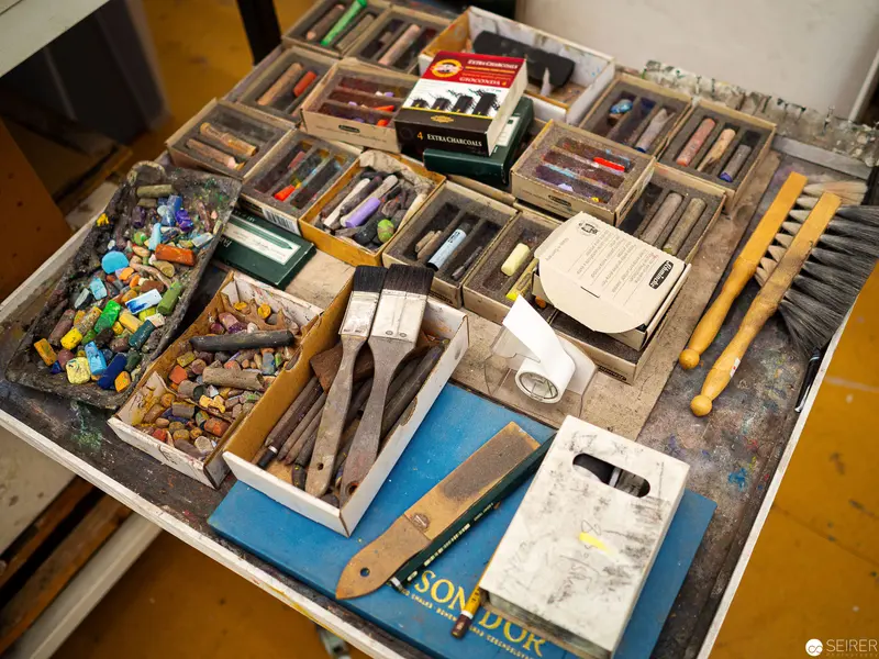 Artist's Workspace: Pastel and Printmaking Tools Meticulously Arranged
