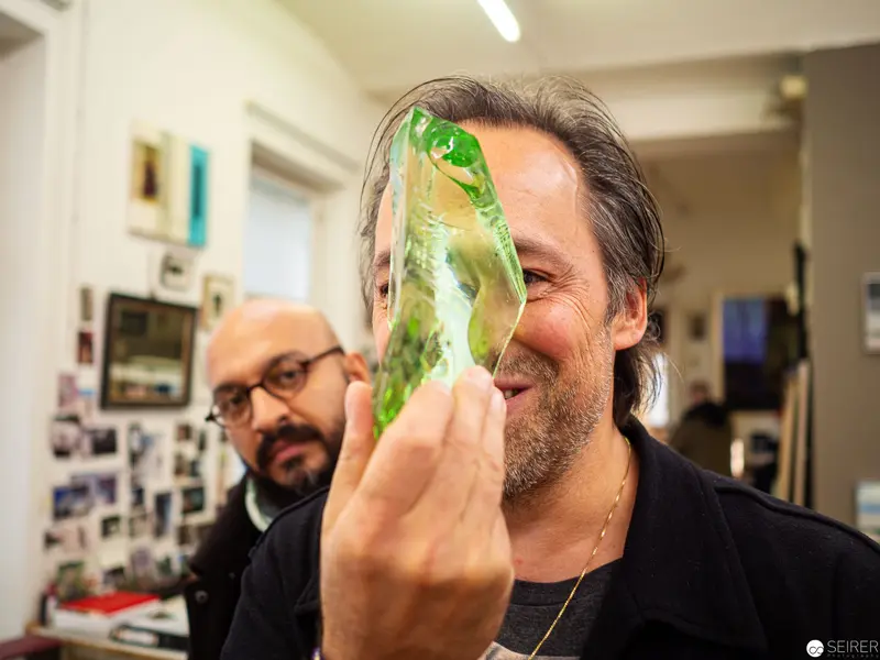 Researcher Examining Translucent Green Organic Specimen in Laboratory Setting