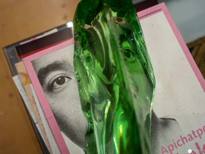 Translucent Green Glass Distorting Black and White Photographic Portrait