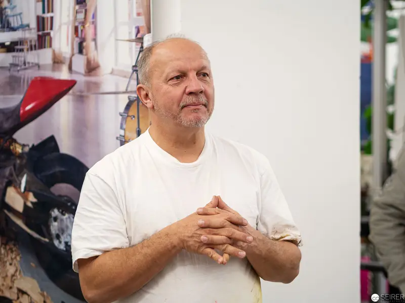 Reflective Moment: Older Man in White Shirt with Contemplative Gesture