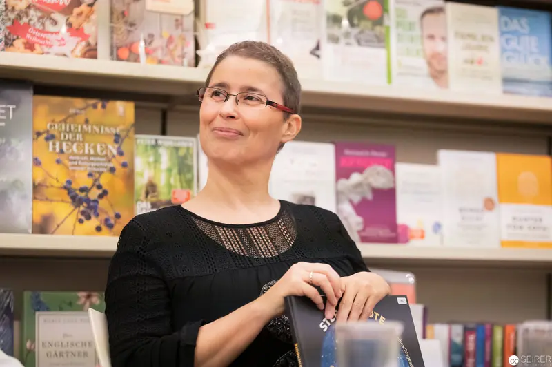 Woman with Book Display at Library or Bookstore Event