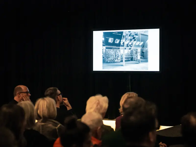 Audience Viewing Projected Architectural Image at Contemporary Art Presentation