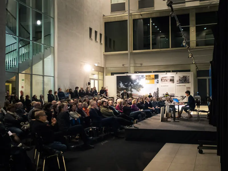 Public Lecture Event in Modern Architectural Gallery Space with Large Audience