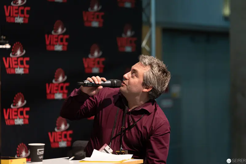 Stefan Cernohuby Speaking at VIECC Book Panel in Purple Shirt